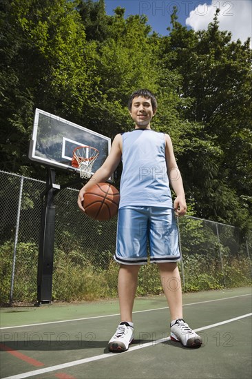 Asian boy holding basketball