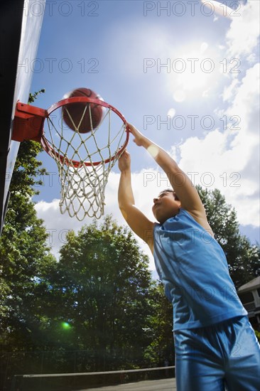 Asian boy playing basketball