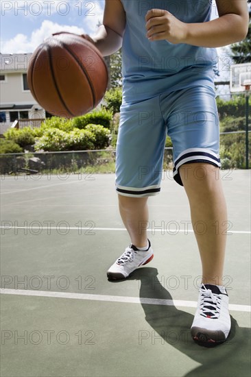 Asian boy playing basketball