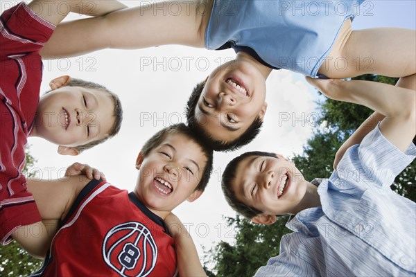 Asian brothers standing in huddle