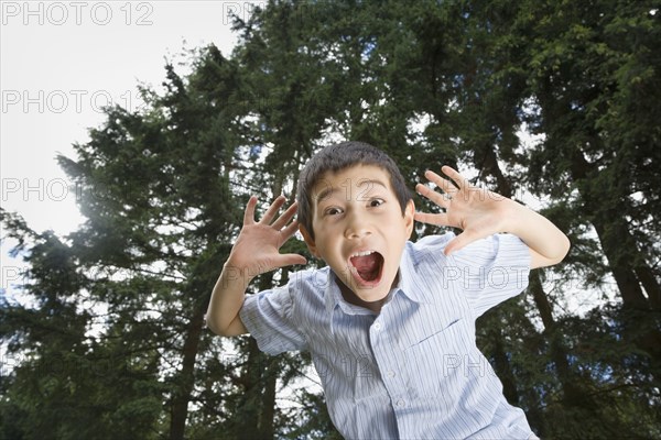 Asian boy yelling outdoors