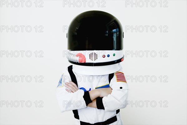 Mixed race boy in astronaut costume