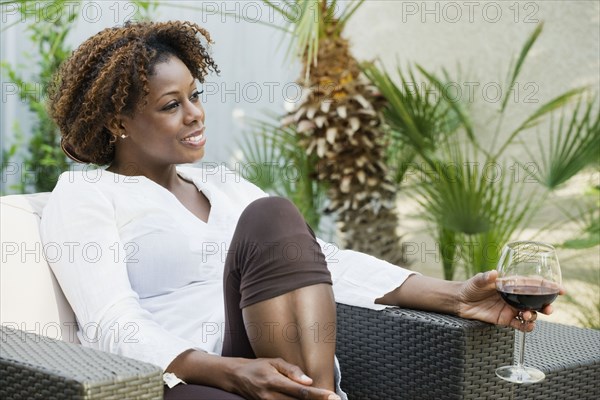 African woman drinking red wine