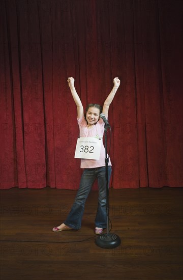 Mixed race girl competing in spelling bee