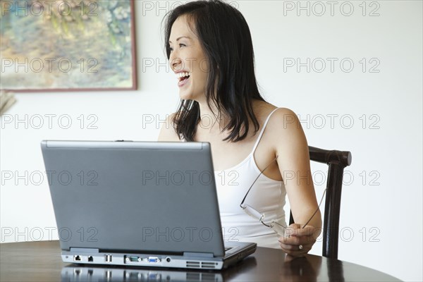 Japanese woman using laptop at table