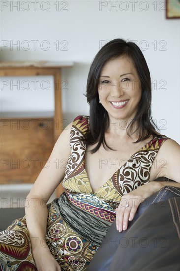 Japanese woman sitting on sofa