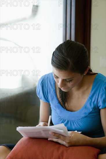 Mixed race woman filling out forms