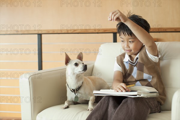 Mixed race boy tempting dog with treat