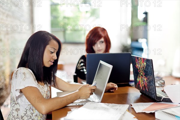 Teenage girls studying together