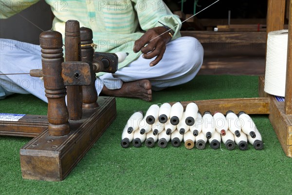 Indian man working with thread