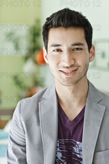 Smiling mixed race man in jacket