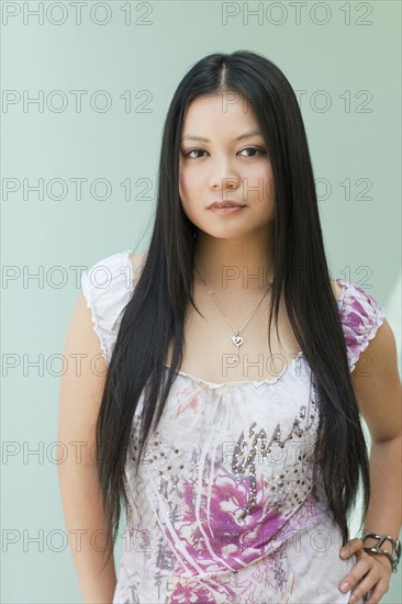 Serious Vietnamese woman with hands on hips
