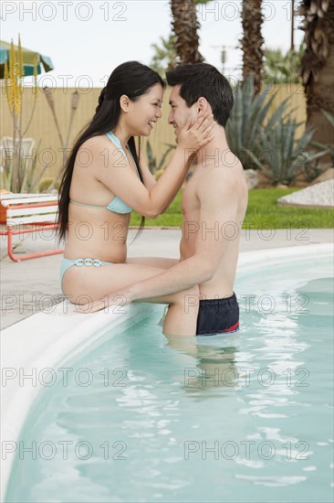 Couple hugging at poolside