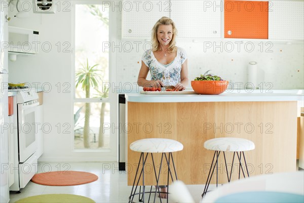 Caucasian woman cooking in kitchen