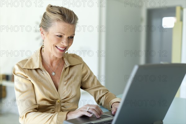 Caucasian woman typing on laptop