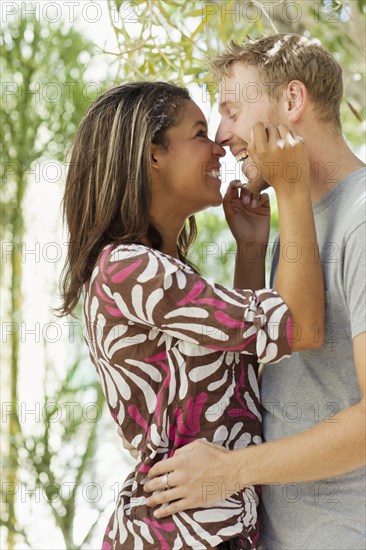 Smiling couple rubbing noses outdoors