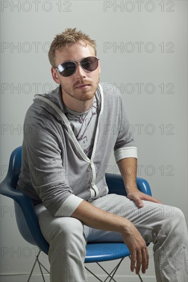 Serious Caucasian man sitting in chair