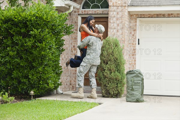 Solder returning home greeting excited wife