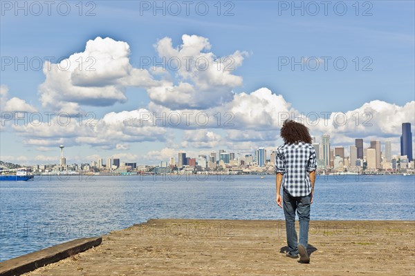 Mixed race teenager standing at urban waterfront