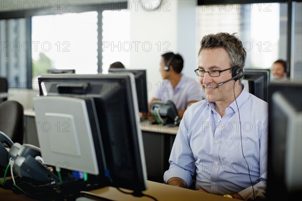 Business people working on computers in call center