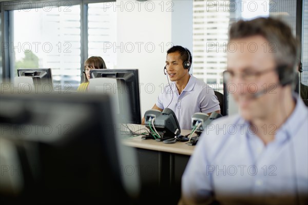 Business people working on computers in call center