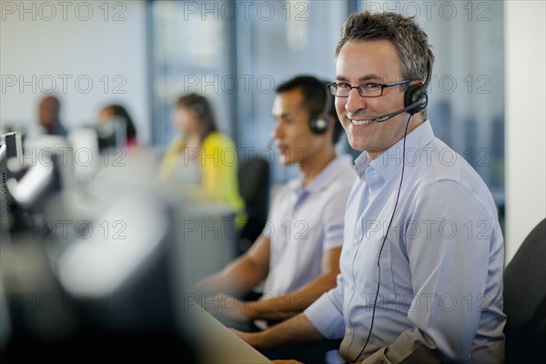 Business people working on computers in call center