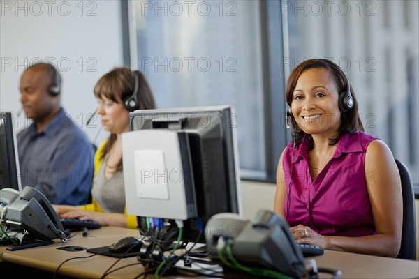 Business people working on computers in call center