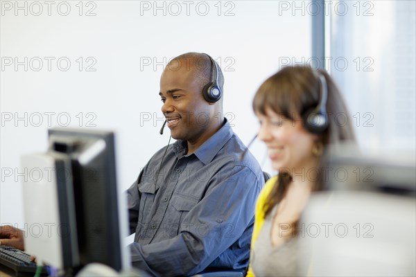 Business people working on computers in call center