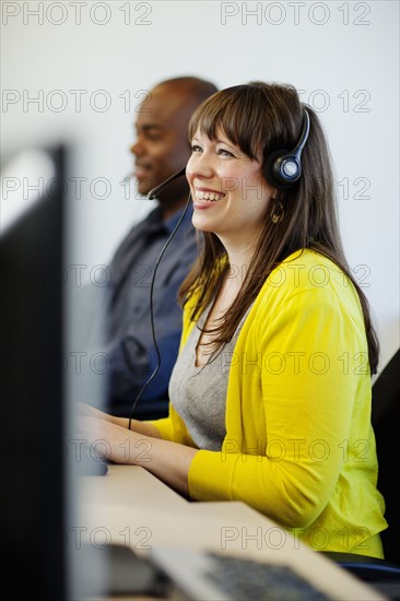 Business people working on computers in call center