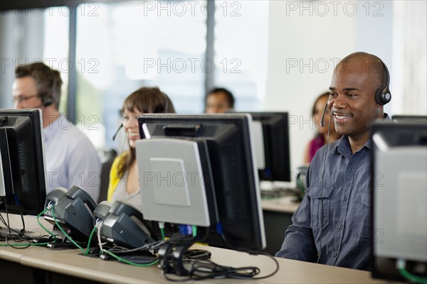 Business people working on computers in call center