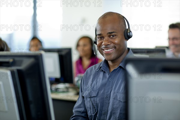Business people working on computers in call center