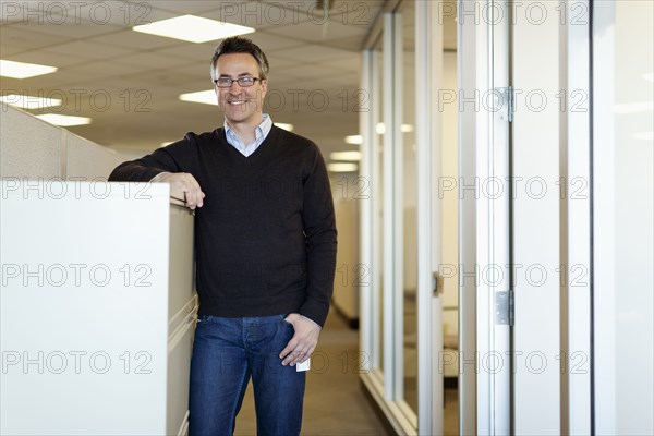 Smiling Caucasian businessman standing in office