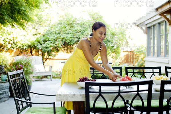 African American woman preparing lunch on patio