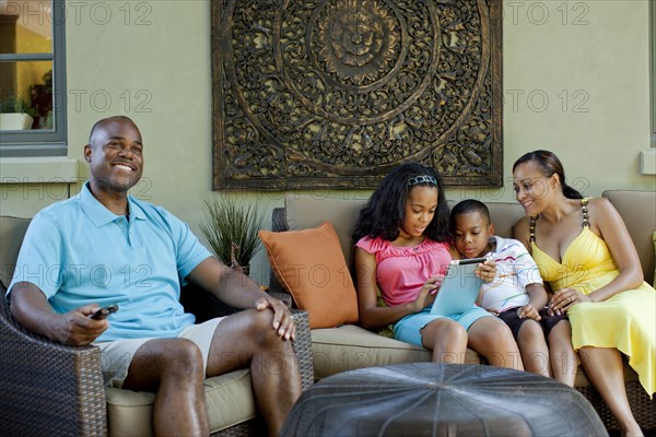 African American family relaxing in living room