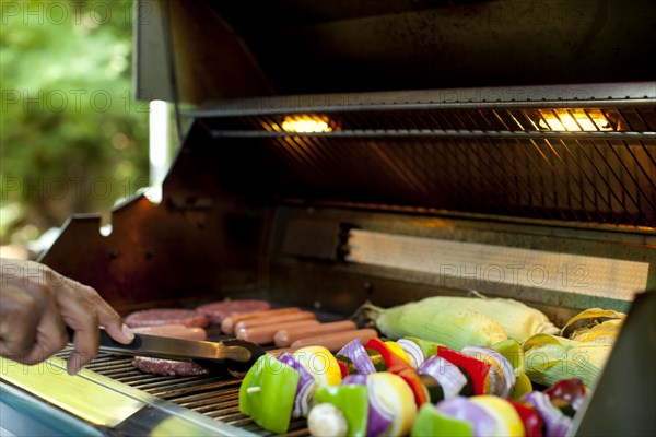 African American man grilling food on barbecue