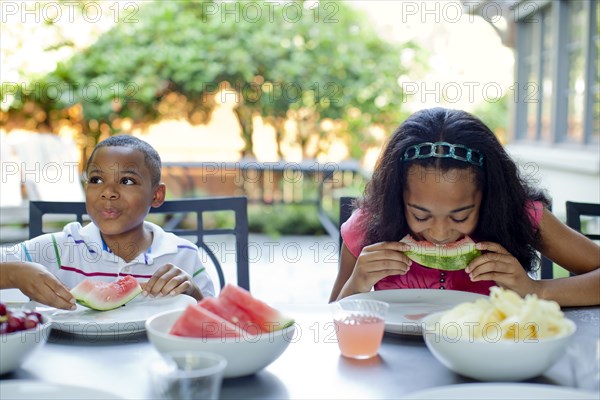 African American children eating lunch on patio