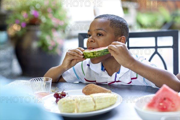 African American boy eating watermelon
