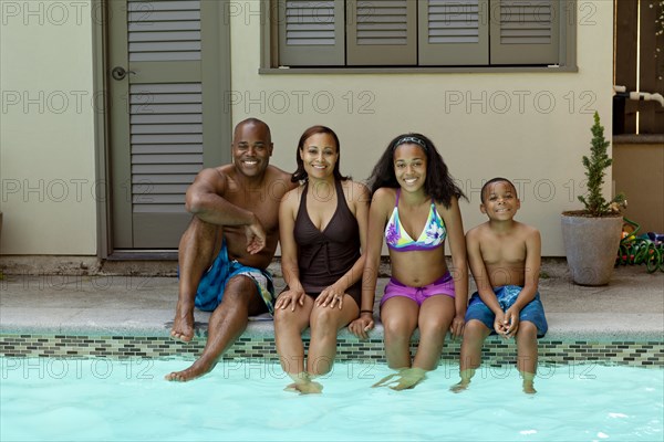 African American family enjoying swimming pool