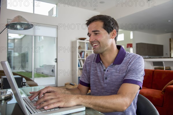 Mixed race man using laptop