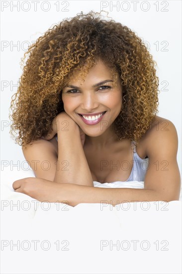 Mixed race woman laying on bed