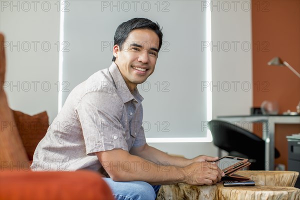 Mixed race man using digital tablet