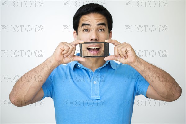 Mixed race man taking digital picture