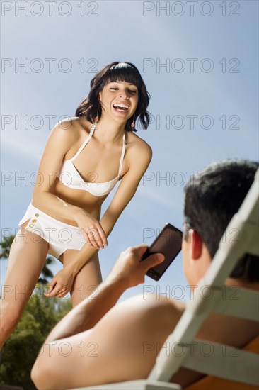 Husband taking picture of wife with cell phone