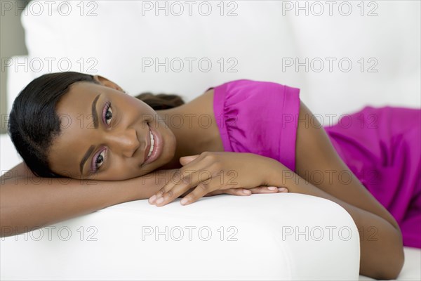 Black woman laying on sofa