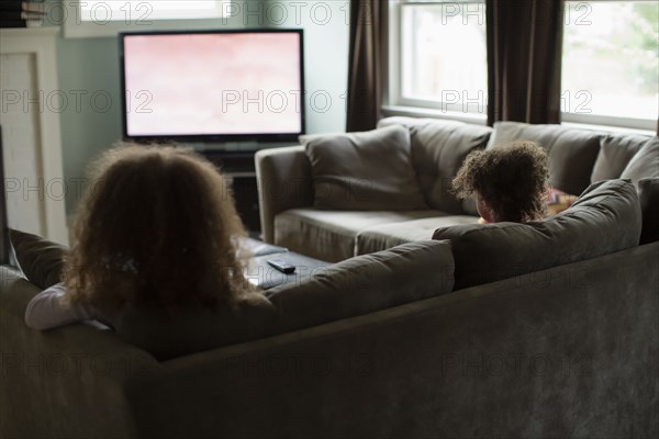 Mother and daughter watching television