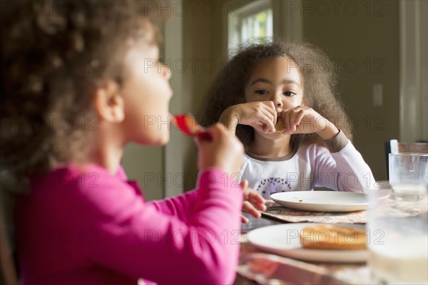 Mixed race girls eating breakfast