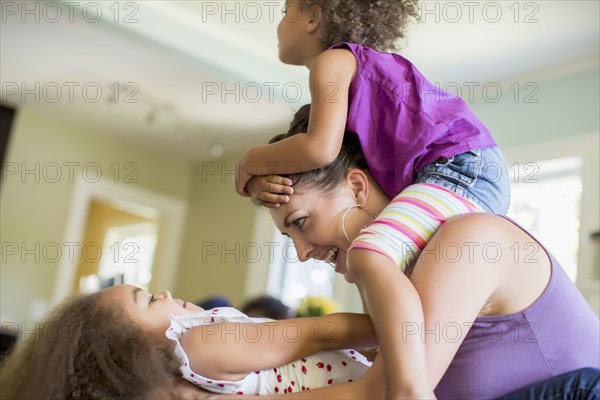 Mother and daughters playing