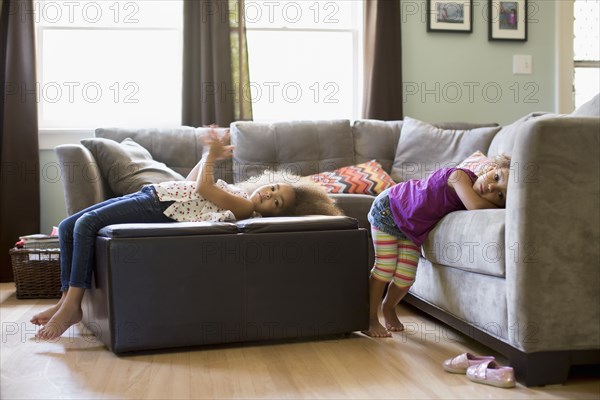 Mixed race sisters in living room