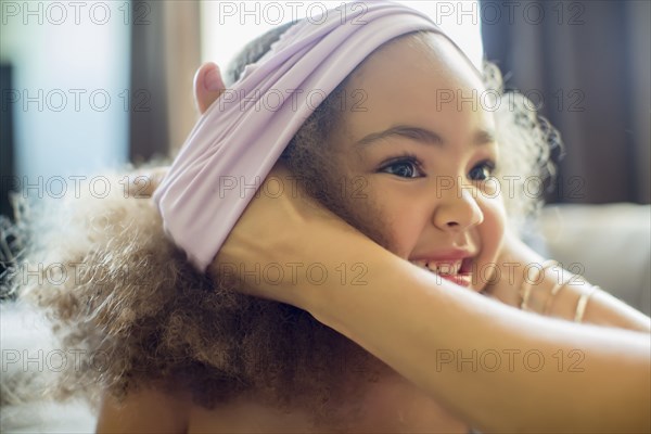 Mother dressing daughter