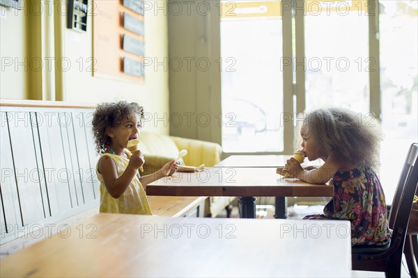 Mixed race girls eating ice cream cones